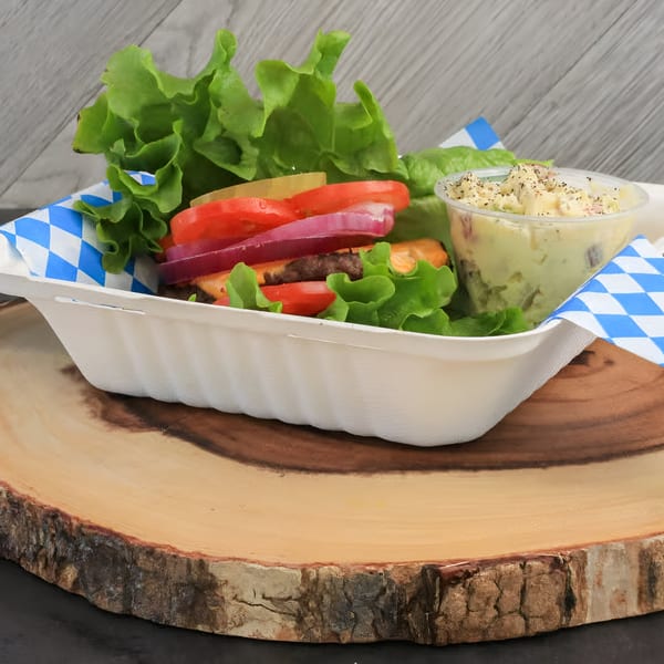 Chilly Jilly'z burger with lettuce, tomato, onion, and pickles, served with potato salad.
